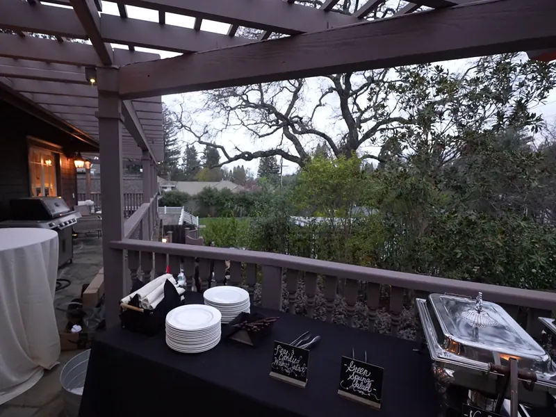 Chafing dishes staged on a shaded deck for a Santa Cruz backyard dinner