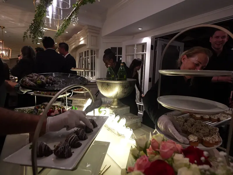 Server passing dessert bites during a reception near the Santa Cruz harbor