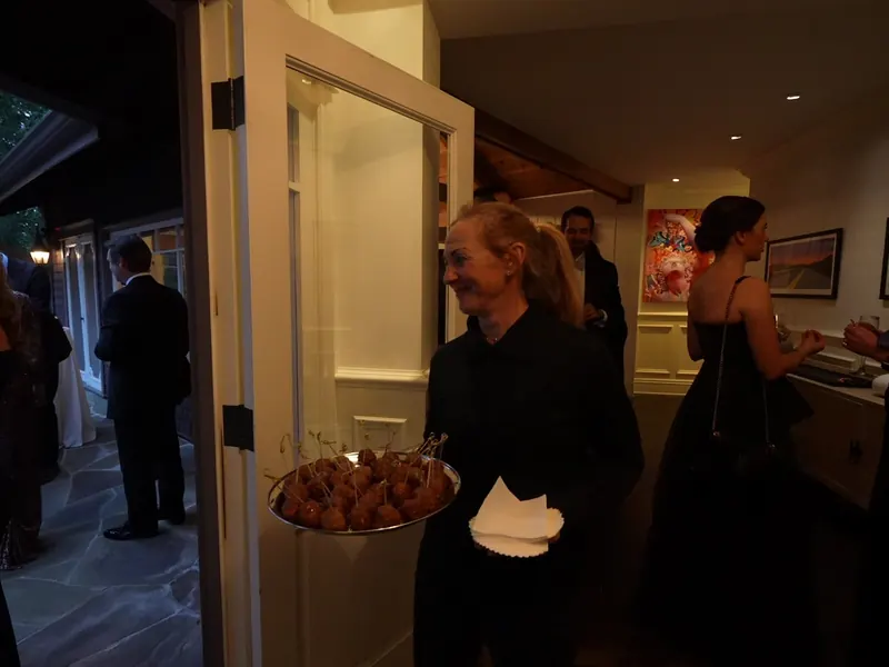 Guests arriving with appetizer trays at a UCSC campus reception