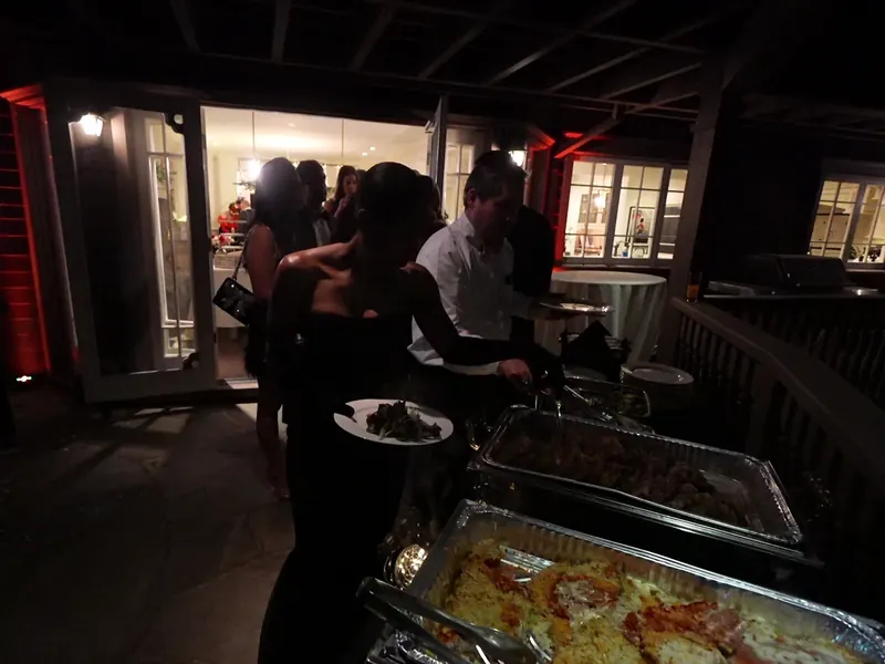 Guests moving through a hot entrée line at a Scotts Valley evening party