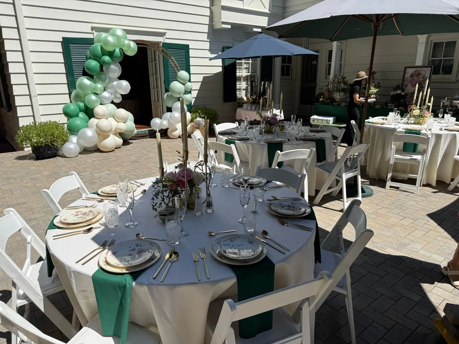 Tables set outdoors for a catered lunch on a warm afternoon